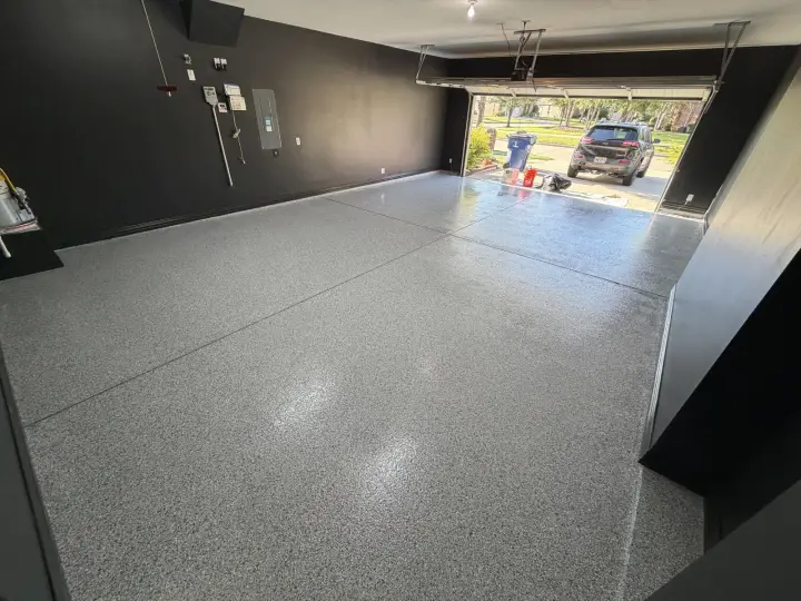 Finished Frisco garage showing Iron Ore Eg-Shel walls under daylight from the open garage door.