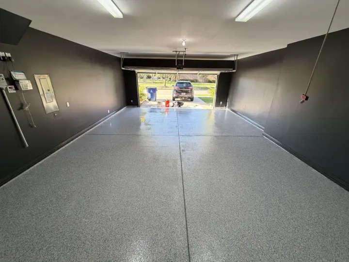 Finished Frisco garage with Iron Ore painted walls and trim, a Pure White ceiling, and a full-flake floor.