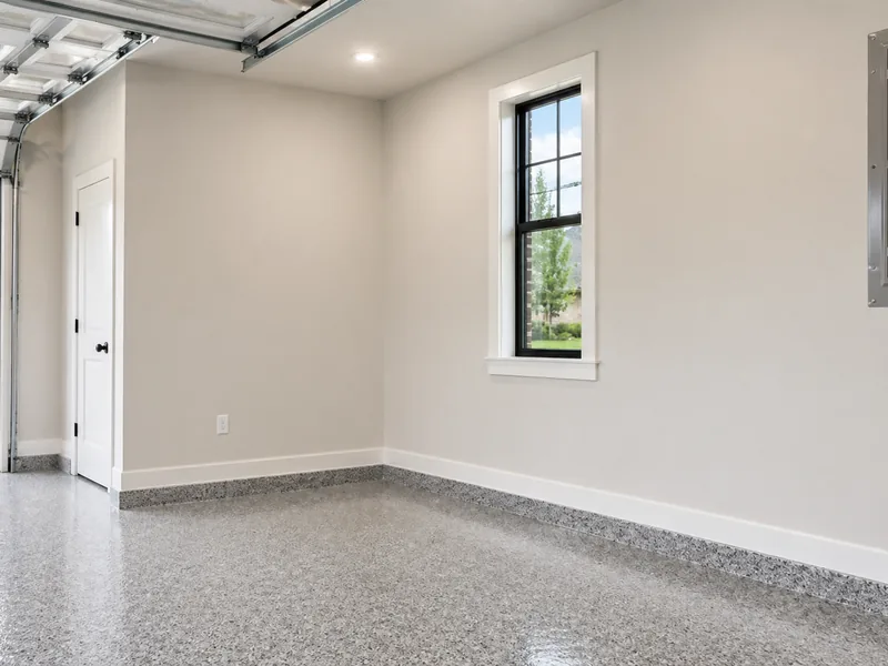Garage with light painted walls and white trim