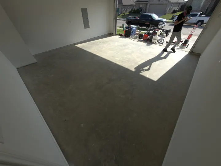 Before photo of the Azle, Texas garage floor coating project area.