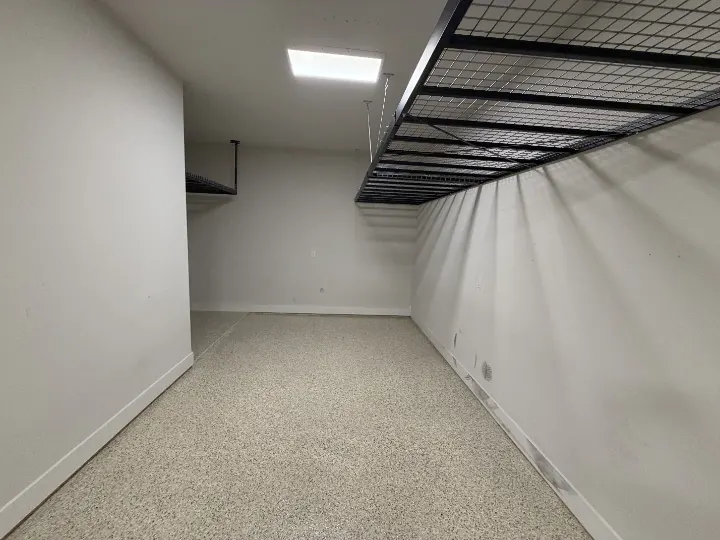 Garage storage rack and beige epoxy floor in Midlothian, Texas.
