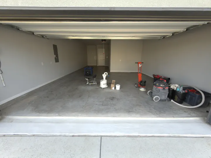 Garage interior with equipment and tools before floor coating in Prosper, Texas