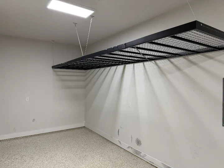 Overhead storage rack in a garage with epoxy floor coating
