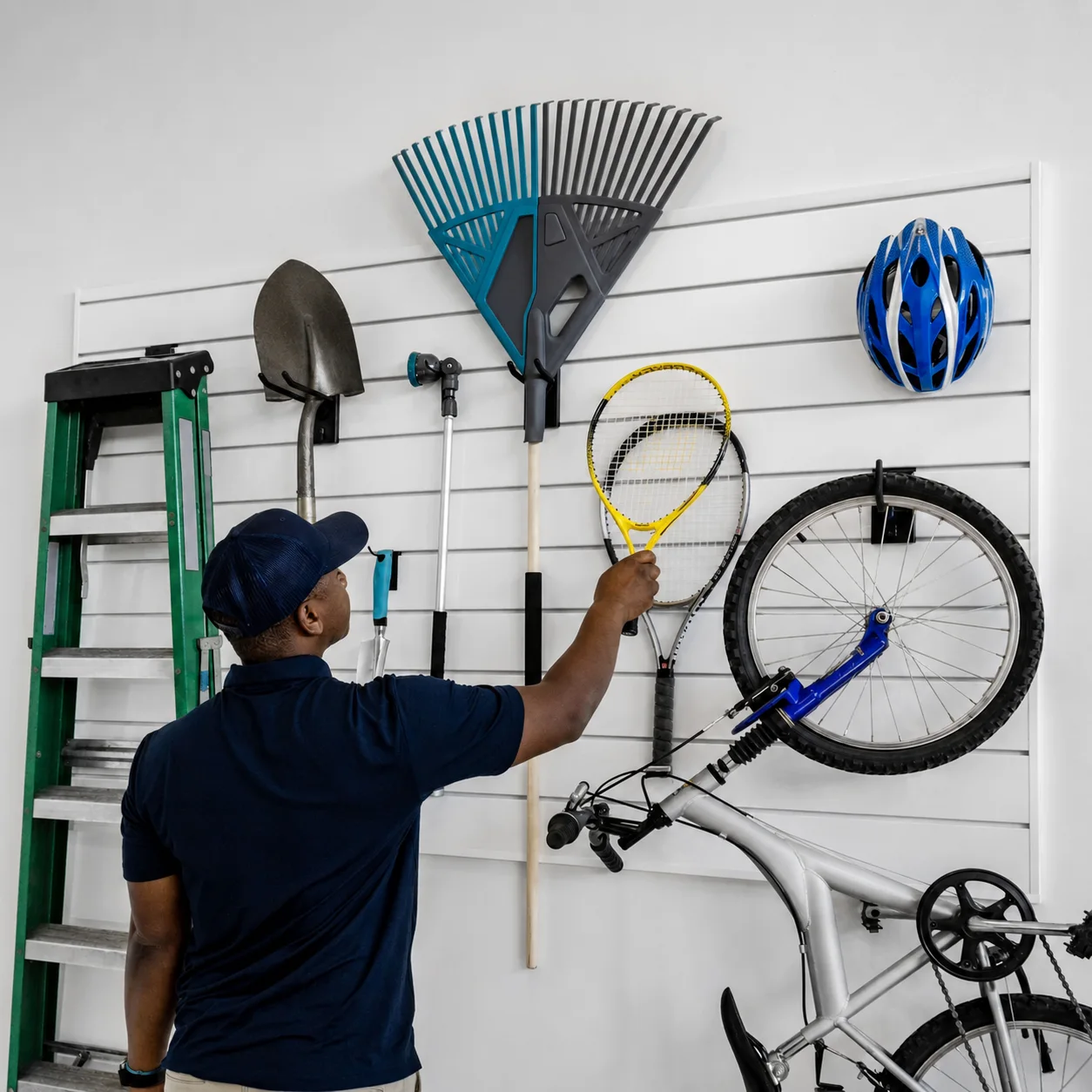 Unbranded slatwall storage zone with adjustable hooks for sports and household gear