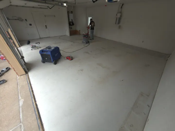 Before photo of an empty garage with a concrete floor in Arlington, Texas.