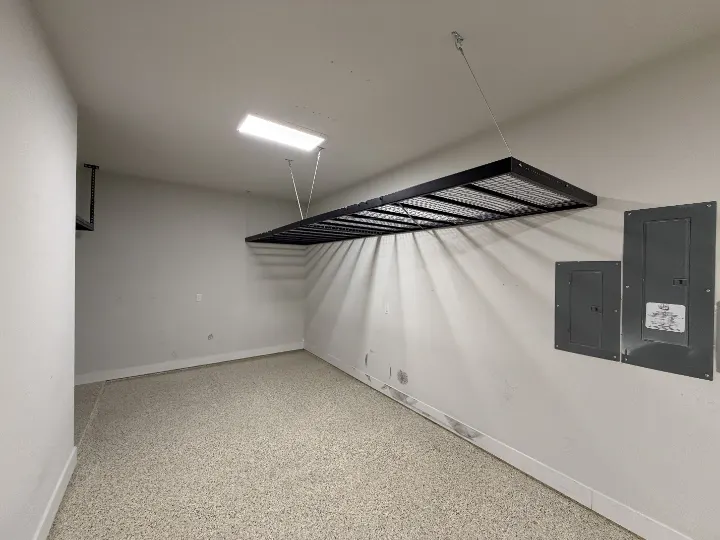 Installed overhead storage rack in a garage with epoxy floor coating
