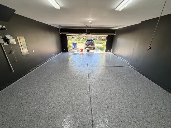 Frisco garage floor with Tidal Wave epoxy flake coating and dark grey walls.